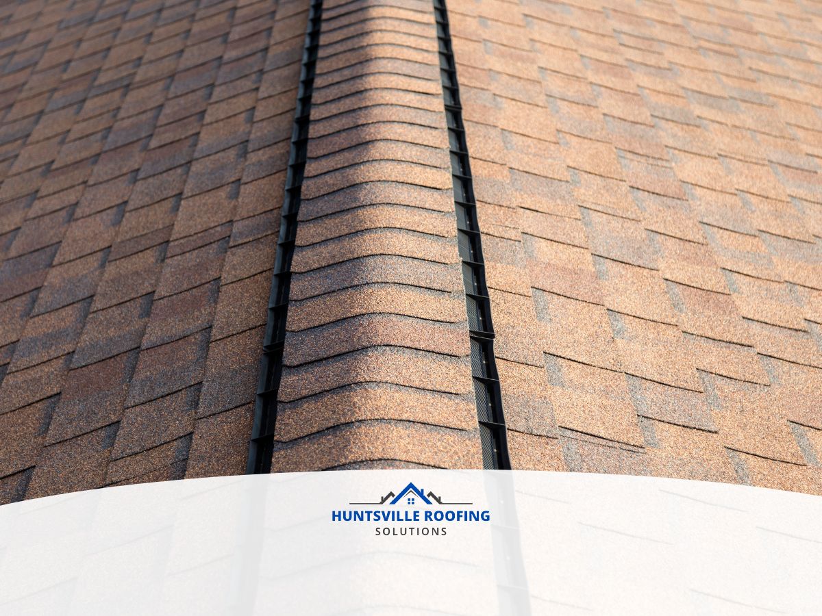 Weathered brown asphalt shingles and ridge vent on a North Alabama home showing heat and humidity wear
