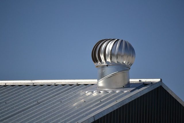 Silver wind turbine vent installed on a metal roof