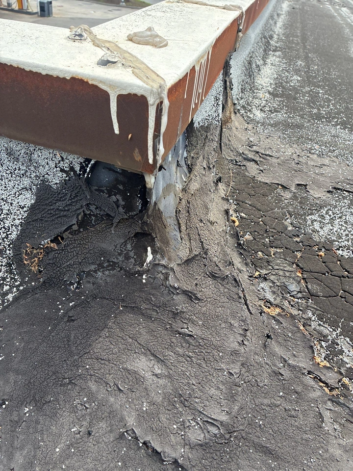 Cracked roof sealant and deteriorated flashing at a likely water-entry point