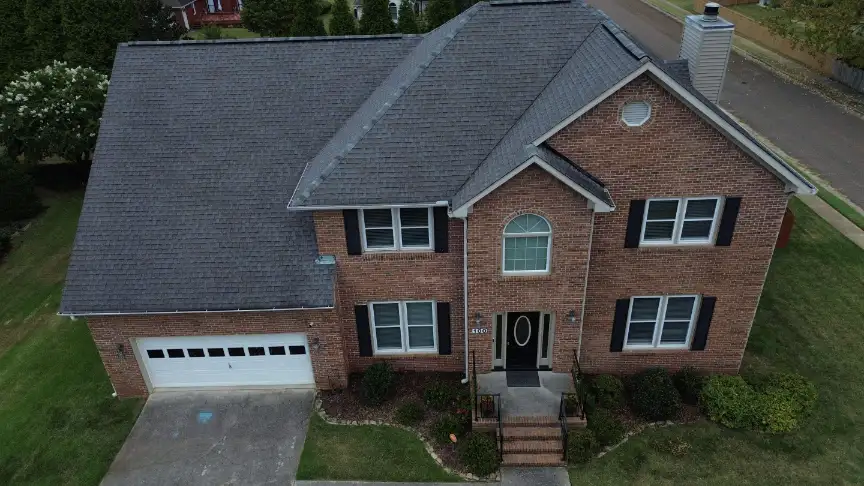 Two-story brick home with a new roof and arched entry window