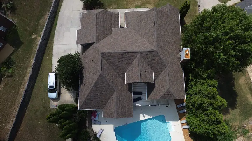 Completed complex roofline on a home with a poolside patio near Lake Guntersville