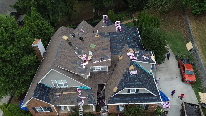 Local roofing contractors staging fresh materials and underlayment on a residential roof.