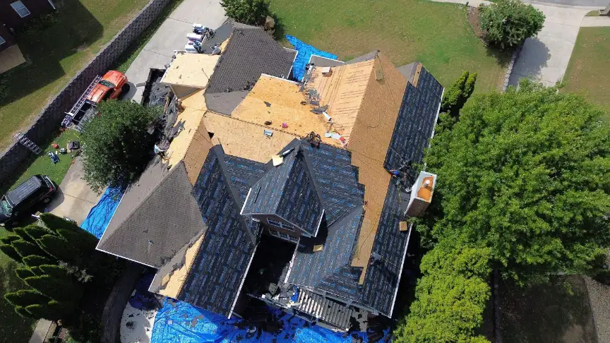 Local roofing contractors performing precise leak repair and patching on a damaged roof in Huntsville AL.