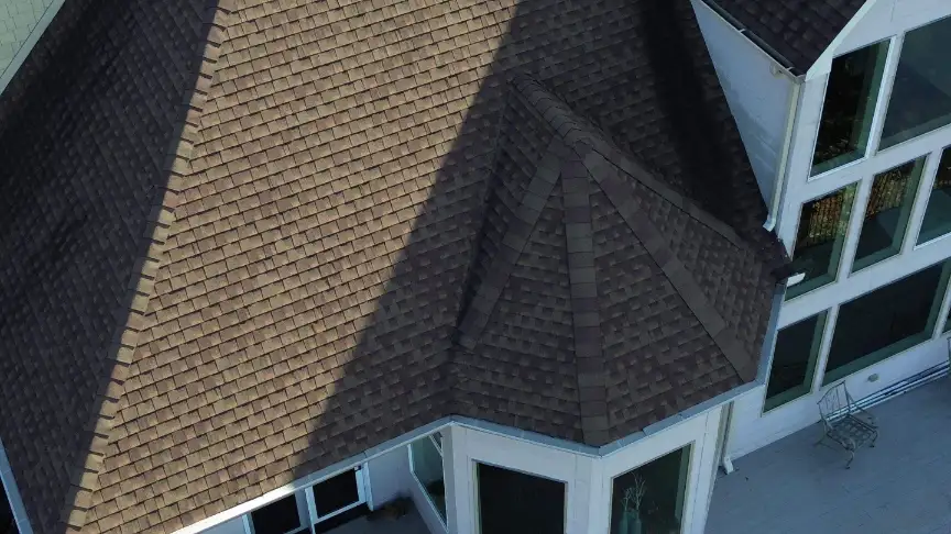 Beautiful brown shingle roof installation featuring complex intersecting rooflines by local Huntsville contractors.