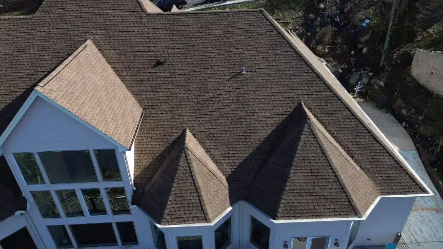 Peaked roof sections finished with brown asphalt shingles in Hazel Green Alabama