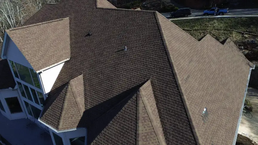 Complex brown shingle roof on a large Hazel Green property