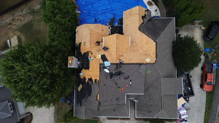 Roof repair in progress with protective tarps ensuring the home remains watertight.