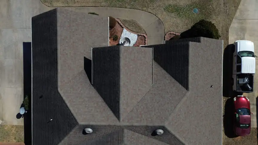 Multi-slope roof completed above a landscaped front yard and circular drive