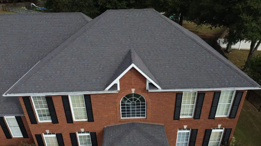 Grey shingled roof with arched window detail on a Hazel Green brick house