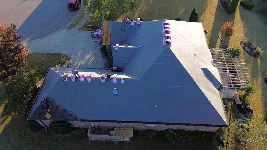 Roofing contractors in Hazel Green staging shingles on a roof replacement project