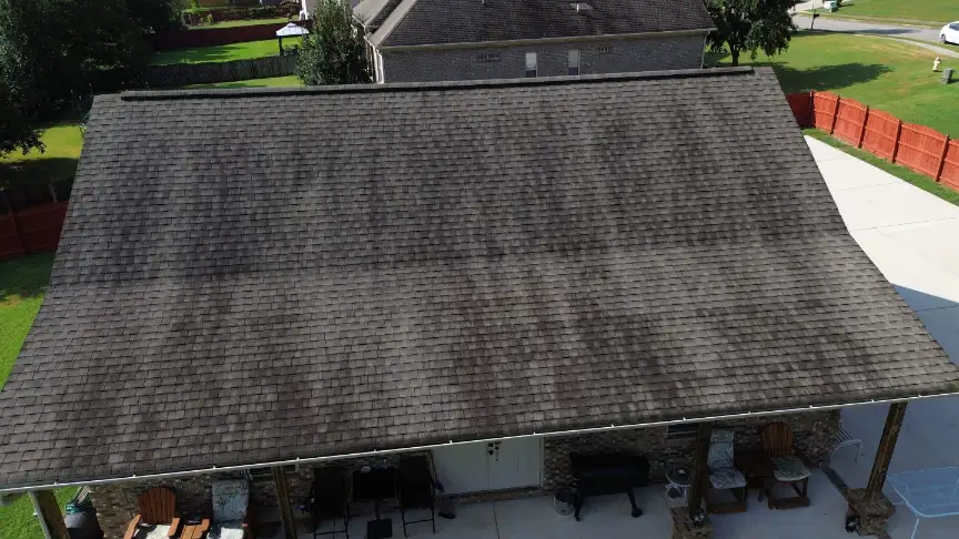 Dark algae streaking on a shingle roof in humid North Alabama, often mistaken for sun fading
