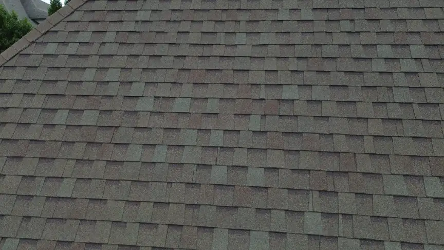 Close-up of gray and brown asphalt shingles on a residential roof