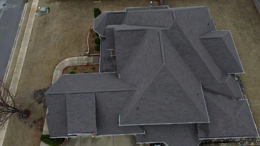 Completed gray shingle roof on a multi-plane roofline