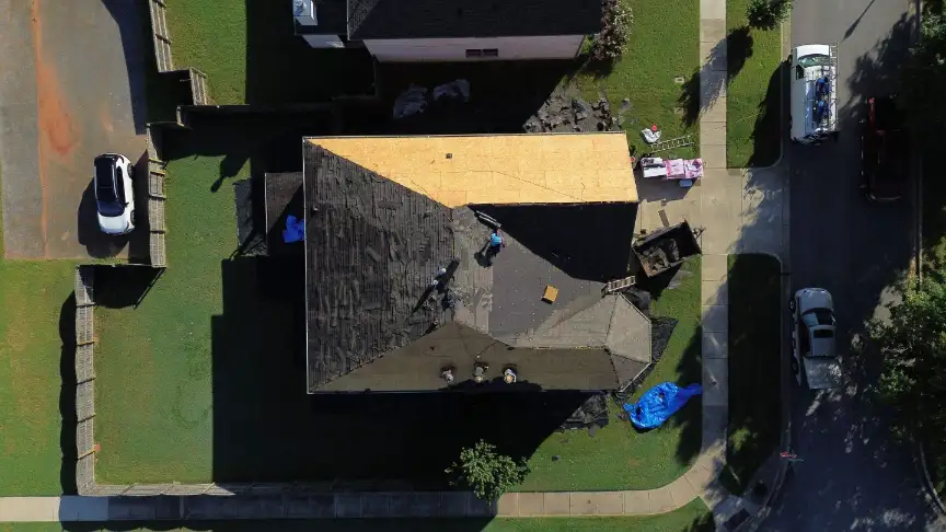 Huntsville roof replacement process showing new plywood decking installation.